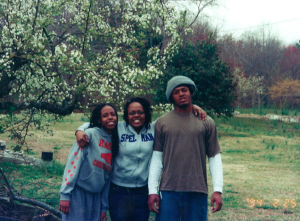 Sydney with younger sister Rhendy and brother Jay. Thaxton laughed, We were outside picking up sticks. One of the many “fun” tasks my dad used to make us do, hence my brother’s “pleasant” face.